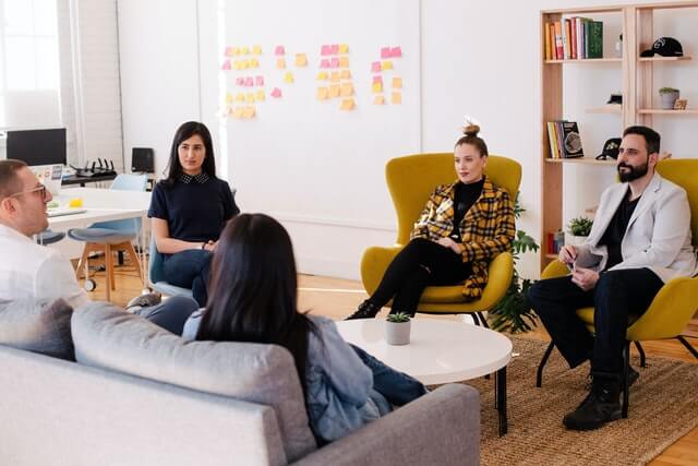 People sitting in a room with a table