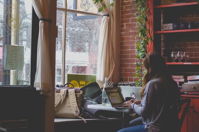 Woman using the computer in a cafe.