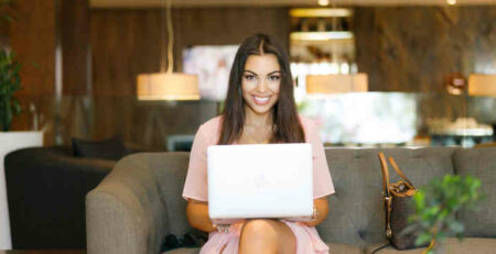 A woman using a laptop.