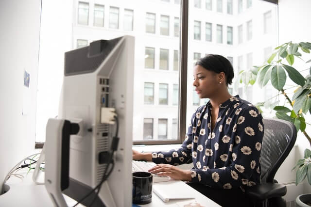 Woman using a desktop computer.