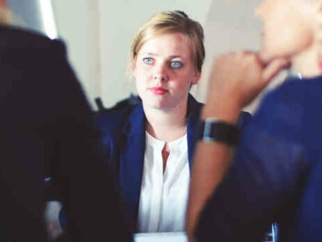 Three women in a meeting.