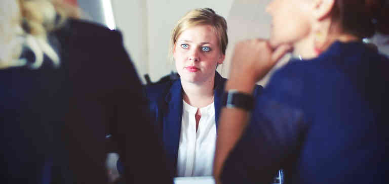 Three women in a meeting.