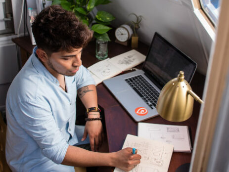 Man sitting at a desk and working on a computer.