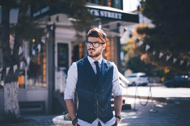 A man in a suit walks on the street.