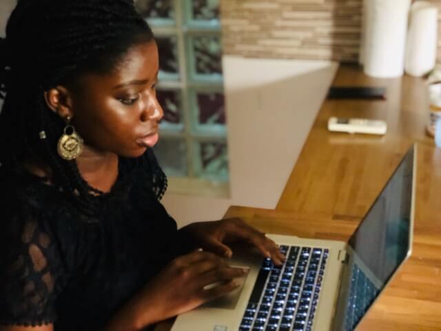 A woman working on her laptop.