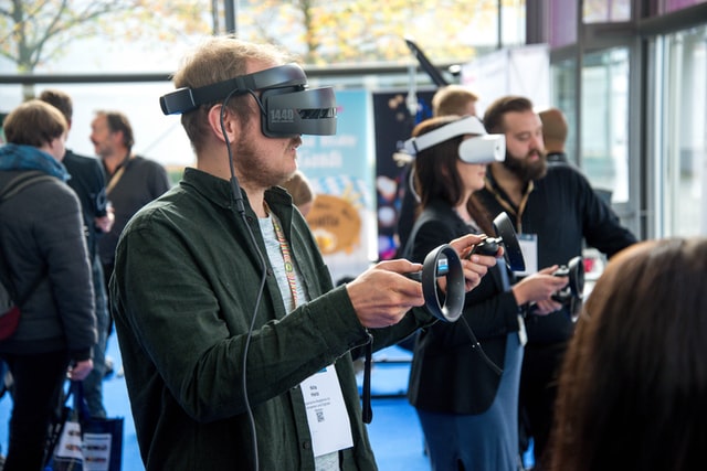 People wear virtual reality masks in a sunny room.