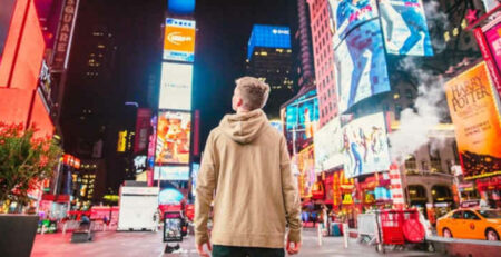 A man looks at advertisements in Times Square.