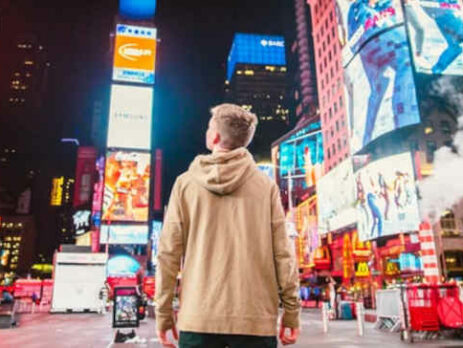 A man looks at advertisements in Times Square.