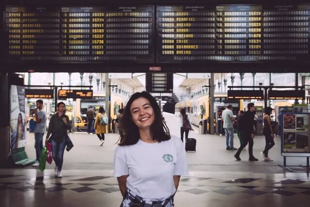 A woman smiling in a train station.