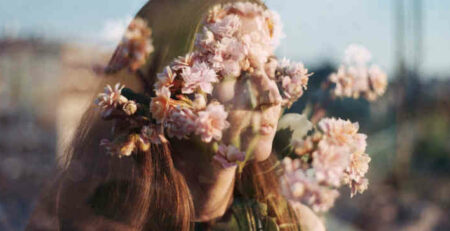 A double exposure of a woman and some flowers.