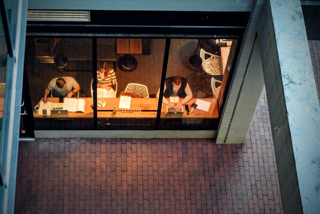People work in a cafe in the late afternoon.