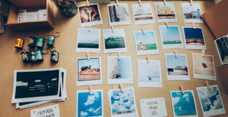 Developed film and photos arranged on a desk.