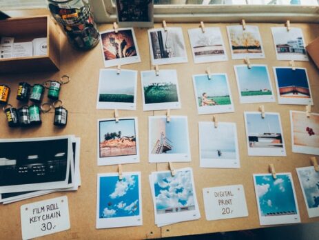 Developed film and photos arranged on a desk.