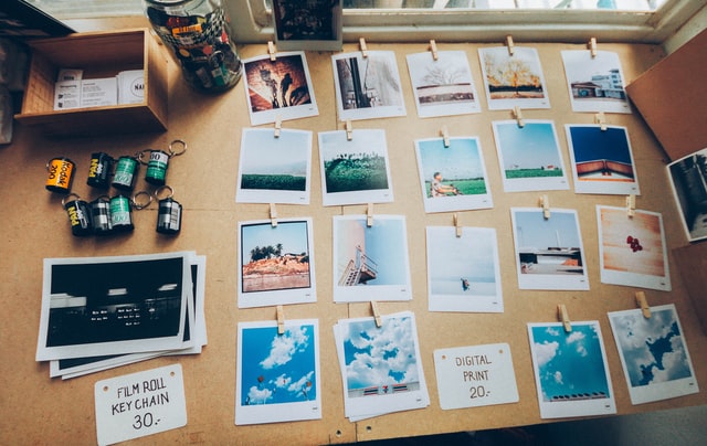 Developed film and photos arranged on a desk.