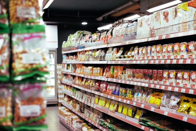 Fully stocked shelves in a supermarket.