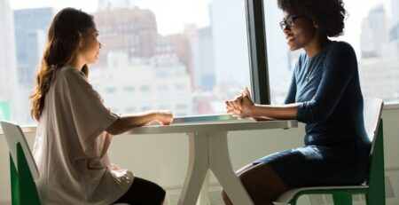 A woman interviews another woman.