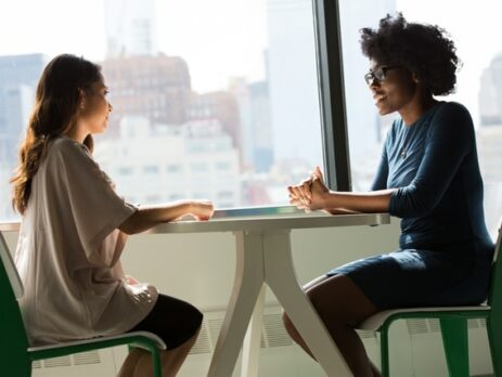 A woman interviews another woman.