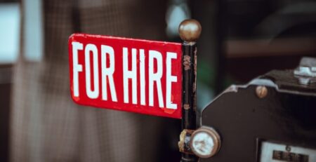 A red and white for hire sign.