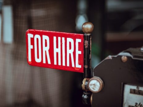 A red and white for hire sign.