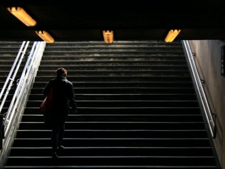 A walks upstairs with a backpack on his back.