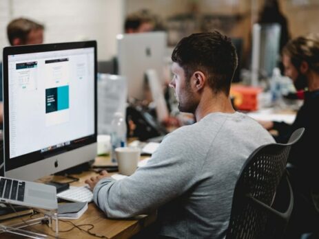 A graphic designer works on a project in the office.