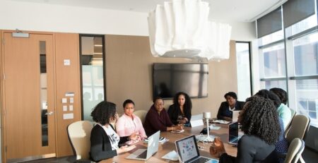 A workplace team sits around a table and negotiates. 