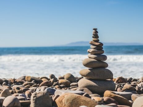 A pile of rocks balances by the sea.