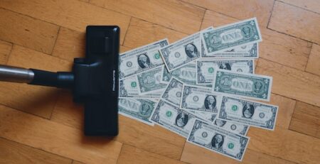 A vacuum sucks up one-dollar bills. 