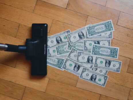 A vacuum sucks up one-dollar bills. 