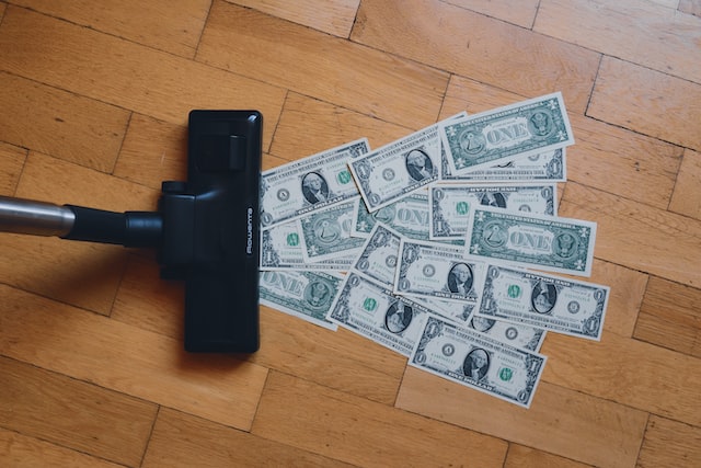 A vacuum sucks up one-dollar bills. 