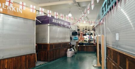 Preparing Your Business and Staff for a Recession Featured Image: https://unsplash.com/photos/a7pUfzMZz3w Caption: N/A Alt-Text: A row of shuttered stalls in an empty mall. It’s inevitable. The market will eventually enter a recession. If not this week or this month, possibly years down the road. Either way, part of owning a business is knowing how you can prepare your staff and company for a recession, should one ever be headed your way. Read on to learn more about how you can prepare your business and staff for a coming recession. What is a Recession? A recession is a period in which the economy declines rather than grows. It’s important to note that this is not the same as a depression, where the economy stays at all-time lows for a prolonged period of time. Rather a recession just sees a decline in sales, among other disheartening indicators. This downturn must last at least a couple of quarters in order to qualify as a true recession. It also must affect all parts of a sector or multiple sectors of a market. Why You Should Prepare for a Recession Unfortunately, recessions disproportionately affect small businesses, and one study performed during the great recession from 2007-2010 showed that over 5% of businesses per year ended up closing due to the economic downturn. The point is, no matter what type of business you are running, there is a huge chance you could go under during a prolonged, difficult economic period like a recession. The only way to prevent this from happening is to take steps in advance to prepare for a recession. Some preparations are easier than others, but you should take the time to do as many things as you can to prepare your business and staff for difficult times before they arrive. After all, there’s no use in preparing for a hurricane after it’s already happened. Image #2: https://unsplash.com/photos/JW6r_0CPYec Caption: There are many ways to prepare your business for a recession in advance. Alt-Text: A dollar bill on a white countertop. 8 Steps to Prepare for a Recession Whether you think negative economic times are on the horizon or not, here are some steps you can use to prepare your business for a coming recession. 1. Save Money Is your business operating on thin margins? This is a recipe for disaster during tumultuous times. Although it may not be a recession now, it’s time to take a look at your profits and save what you can for the future. Every business needs to have at least a couple of months of expenses in reserve, the more, the better. You should be building that buffer now while sales are plentiful. When you start trying to save, you may discover that your margins are too thin to allow you to do so. Now is the time to make price changes, so that isn’t the case because if you make price changes after you have already started losing a large number of sales, it will only quicken the process. 2. Diversify The companies that don’t last through a recession are those which only offer one product. Offering only one product, even in the best economic times, is risky because a replacement for that product could be made tomorrow, putting you out of business even in a bull market. Now is the time to consider diversifying your business into another area. For example, if you’ve only offered graphic design services in the past, consider offering copywriting as well, in case something were to happen to the graphic design market. If you are creating a new product, remember the sales cycle and how long it takes to bring a product to market. If the market is in a downturn already, it probably isn’t the best time to introduce something new, but this doesn’t mean you can’t still diversify. One of the best ways to diversify in a market that has already gone sour is to partner up with another business where you offer their product, and they offer yours. It may also be time to look at other sales tactics for your products. For example, in the past decade, many companies have found success selling products with subscription-based selling. 3. Lower Expenses Take a look at your budget. Are you spending close to what you make each month (besides the amount you are saving?) This isn’t a good idea when a recession is approaching, and it’s best to cut spending now. This doesn’t mean you are going to cut corners, just unnecessary spending. If you spend enough time looking at your budget, you will find something that can be cut, for example, maybe an employee has been asking to go part-time, and now would be the time to grant that request. Perhaps you’ve got an employee who has submitted their notice. Rather than investing money into a lengthy hiring process, consider hiring a contractor to do the same job. This will give you a skilled employee that you can lay off much easier if times get tough. 4. Make Changes to How Employees Work One of the biggest expenses most offices have is well, the office itself. During the COVID-19 pandemic in 2020, many businesses found that employees work just as efficiently at home as they do in the office. Therefore it might be time to take a big step and downsize your office space. While you may not be able to send all employees to work from home, send the ones that you can, and get a smaller office space just for those that have to be there in person. This can free up lots of capital for other areas of the budget, plus your employees will probably love it. 5. Be Honest With Your Employees The number one complaint employees have when they are laid off is that they didn’t see it coming or that their job lied up until the last minute that there would be layoffs. While it may seem odd, don’t lie to your employees. Now you shouldn’t go right out and say there will be layoffs, but be open with your employees about how layoffs could look (who is at risk? Who would go first?) Then let them know that you are open to ideas for helping the company save money or methods for increasing sales. You may just be surprised at how understanding your employees are because of your honesty, and they may just have an idea to boost sales you haven't thought of yet! Many companies don’t want to tell their employees there might be layoffs because they are afraid the employees will find new jobs. This is never a reason not to notify your employees of a potential layoff. If they do go out and find another job, this is good for you, as you can either have their position absorbed or hire a contractor to replace them. Either option sets you up better for a recession than if the employee had stuck around. 6. Be Reserved With Market Predictions During a booming economy, it can be easy to estimate that sales will continue to grow indefinitely and advise that your company orders more and more inventory. This thought process can go bad very quickly, however, as you may find yourself stuck in a recession with a factory of inventory you can’t sell. Instead of expecting continued exponential growth, make more reserved predictions for future sales, and adjust your inventory accordingly. It may also be worthwhile to see if you can order products more frequently, allowing you to make smaller changes based on actual sales rather than predicted growth. 7. Consolidate Debt All businesses start off with debt. While this debt is necessary for starting a business, it can also be a business’s downfall during a recession. The time to review the debts of your business is not once the recession has started but rather before it even begins. While your company is experiencing a period of growth is when you should look at your debt sheets. After you have your nest egg, consider paying down high-interest debt as quickly as possible. You can also take the time to consolidate debt or even negotiate a new interest rate for some of your most expensive debts. 8. Establish Warning Signals By now, you should be fairly prepared for a coming recession. But don’t get wrapped up in the preparations so much that you forget to also establish what signals you need to be watching for that a recession is here and it’s time to start scaling back. If you have a CFO, this job is probably best assigned to them, as they will be able to watch the cash flow and alert you when there is a fall or significant reduction. If you run a smaller business, make time to sit down each week with the financials each week, taking note when downward trends begin to form. Remember, one bad week of sales doesn’t mean you are in a recession. But if you notice a downward trend over more than four weeks, it might be time to slow your inventory ordering and schedule staff for fewer hours. Signs a Recession is Imminent It’s impossible to fully predict when a recession will arrive, but there are a few signs you should be watching for as a business that may indicate that a recession is imminent. 1. High Inflation Recessions typically follow periods of high inflation because many of the remedies for curbing inflation can lead to a recession. When there is a period of high inflation, this is a good time to start preparing your business for a recession. 2. Economic Instability In the modern age, much of the world is dependent on other parts of the world to provide goods and services. When these supply chains begin to be disrupted by war, famine, and policy changes, this is a sure sign that a recession is on its way. 3. Changes in the Investment Market You aren’t the only one watching for signs of a recession, as most Americans are also watching. Therefore watching their behavior can let you know if a recession may be on its way. If the majority of Americans are switching from high-risk to low-risk investments, this tells you that they are worried about their money as well and are more afraid to lose it. A recession might be right around the corner. 4. Lower Consumer Spending This is one of the more obvious signs, but as a recession begins to loom, consumers will lower their spending. Your CFO, or whoever handles your inventory, should be watching for this sign in particular, as this is one that will directly impact your business. 5. Decline in GDP The final sign to watch for, which is also the clearest, is a drop in GDP. Once a drop in GDP occurs, it is almost 100% likely that the country is in a recession, and it is time to start hunkering your business down to survive. Image #3: https://unsplash.com/photos/-mR1iZFz4AE Caption: It’s important to stay vigilant for signs of a coming recession. Alt-Text: People man reads a book in a coffee shop with headphones on. How Do You Know Your Business is Ready for a Recession? Have you done everything on this list but aren’t sure if your business is truly ready for a recession? The best way to know is to take a look at the financials of your business. Do you have a reserve of cash to last you for a few months? Then you are more prepared than most other businesses out there. If you also have high margins, contingency plans for excess staff, and a variable inventory you can adjust within a few weeks' time, then you are more prepared for a recession than most businesses on the market. Ready to Prepare Your Business for a Recession? No matter how you look at it, preparing your business for a recession is a necessary part of owning a business. Whether you are in the service or products sector, a recession hurts businesses everywhere, and many could go under. Help protect your business from going under by preparing in advance and if your business is struggling, in general, to make ends meet, even in a booming market, take a look at how to win an audience as an underdog brand to help you to find your place in the market. WordPress Information: Permalink: https://www.icreatives.com/preparing-for-a-recession/ Meta Description: Learn about how you can prepare your staff and your business for a recession so you can survive even the toughest economic times!