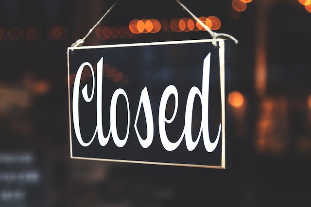 A black closed sign hangs in a window.