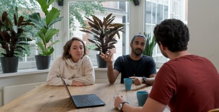 A manager holds a mediation with two employees. 