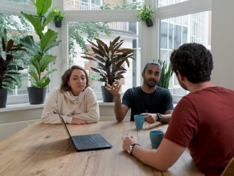 A manager holds a mediation with two employees. 