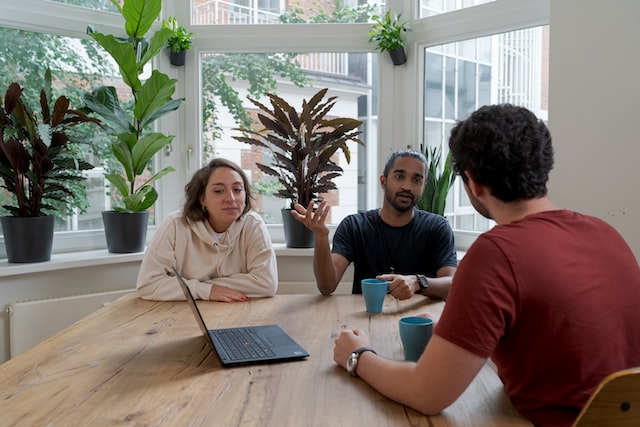 A manager holds a mediation with two employees. 