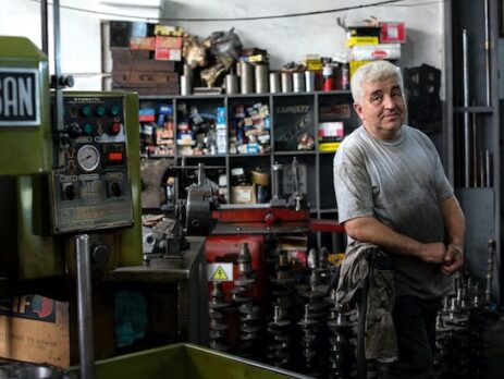 A man stands in a family-owned mechanic shop.