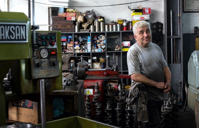 A man stands in a family-owned mechanic shop. 