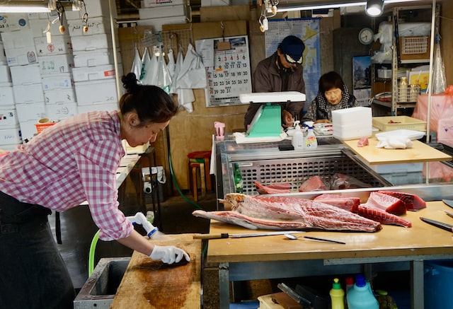 Three people work in a family-owned butcher shop. 