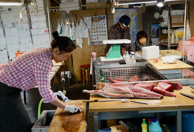 Three people work in a family-owned butcher shop.