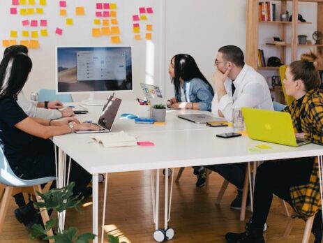 Multiple professionals engage in a meeting. 