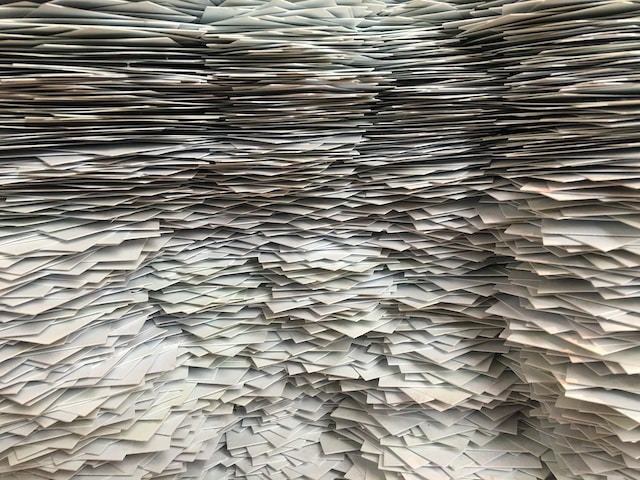 Stacks of white paper from the bottom of the frame to the top. 