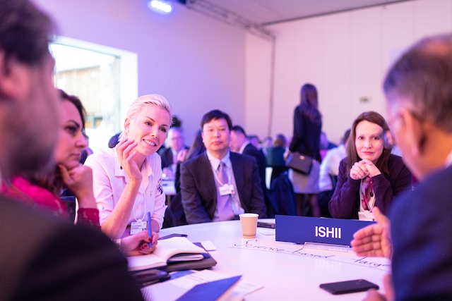A group of people sit around a table during a networking event.