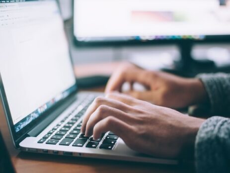 An individual researches data on a laptop computer. 