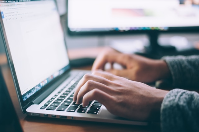 An individual researches data on a laptop computer. 