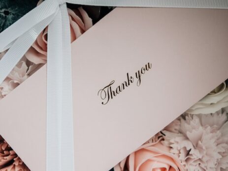 A thank you note on top of flowers.