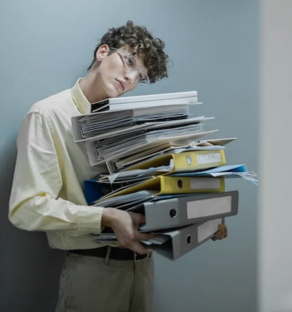 Employee holding a stack of documents.