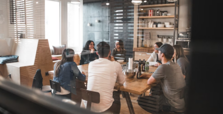 A group of people holding a meeting.