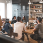 A group of people holding a meeting.