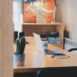 An empty office with a laptop on a desk.