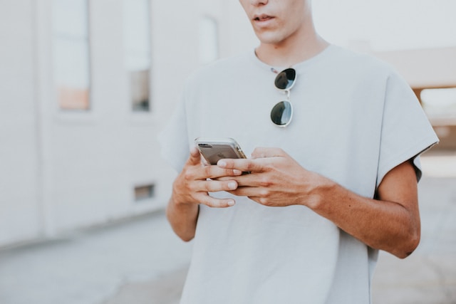 A Gen Zer looks at something on their smartphone.